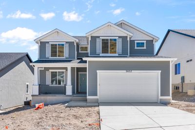 View of front of house with a garage and covered porch | Image 1