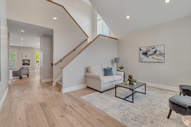 Living area with stairs, light wood-style floors, and recessed lighting | Image 4
