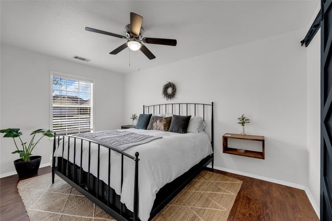 Bedroom featuring a ceiling fan, wood finished floors and baseboards | Image 18