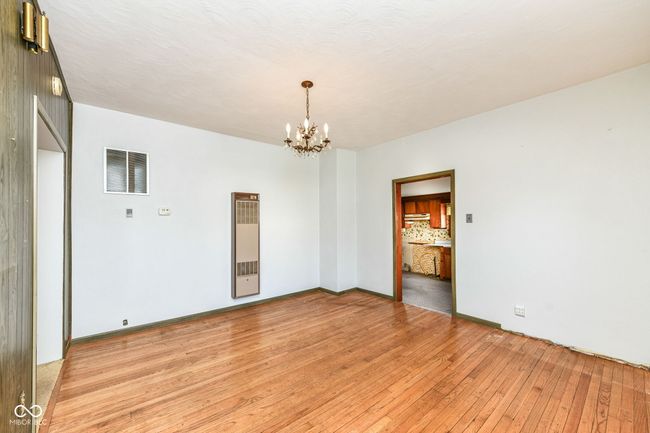 Dining room with beautiful original hardwood floors, entrance into the kitchen | Image 4