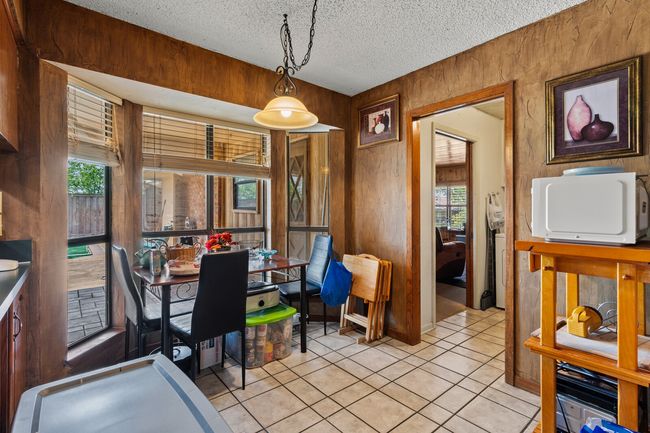 Dining room featuring a textured ceiling and light tile patterned floors | Image 23