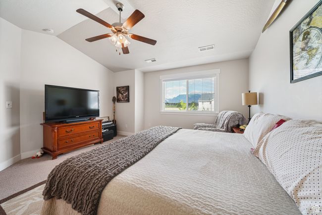 Bedroom with light carpet, lofted ceiling, and a ceiling fan | Image 15