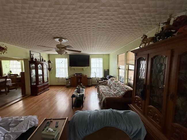 Living room featuring light wood-style floors and ceiling fan | Image 20