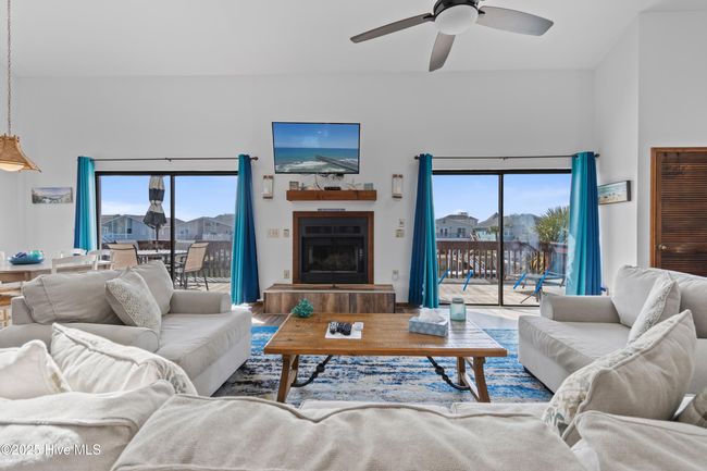 Living Room - Sliding glass doors allow direct view of the canal | Image 5