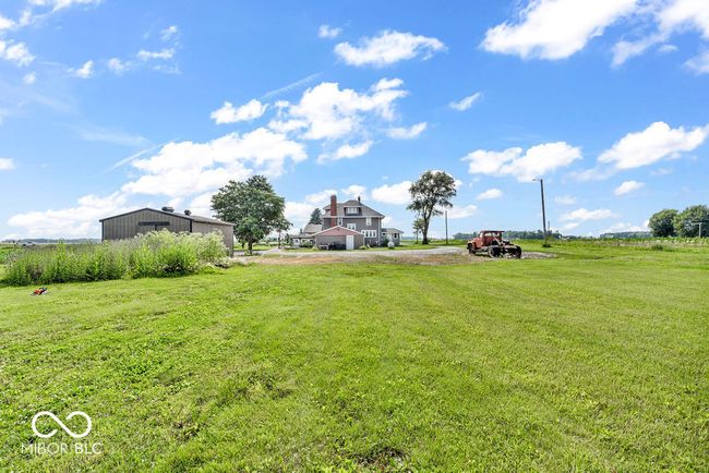 view of green lawn featuring driveway | Image 49