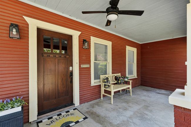 Doorway to property featuring covered porch and a ceiling fan | Image 5