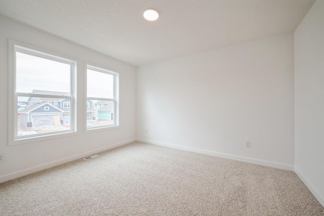 Photo is of the actual home. One of three secondary bedrooms. | Image 11