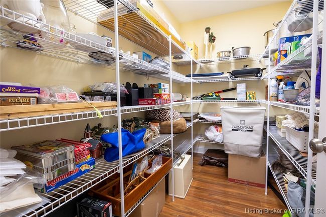 Storage area off laundry room. Custom shelving added. | Image 45