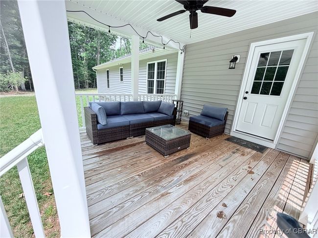 Wooden deck with ceiling fan, an outdoor living space, and a spacious lawn for the children to have a wonderful play area or just relax and enjoy the wildlife. | Image 13