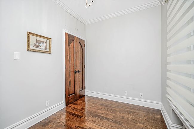 Spare room with crown molding and dark wood-style flooring | Image 28
