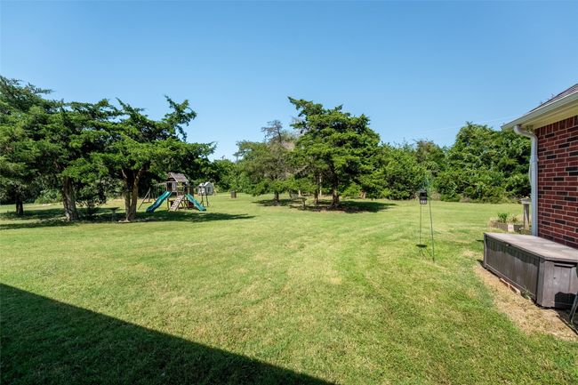 View of green lawn with a playground | Image 17