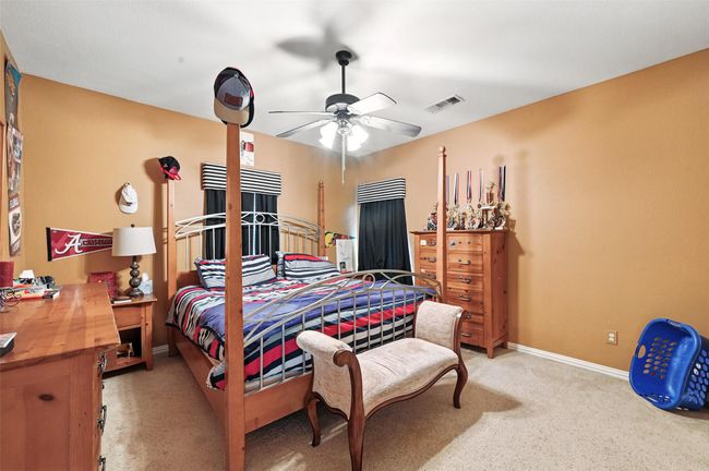 Bedroom with light colored carpet and ceiling fan | Image 22