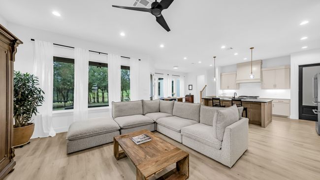 Living area featuring light wood-type flooring, ceiling fan, and recessed lighting | Image 11