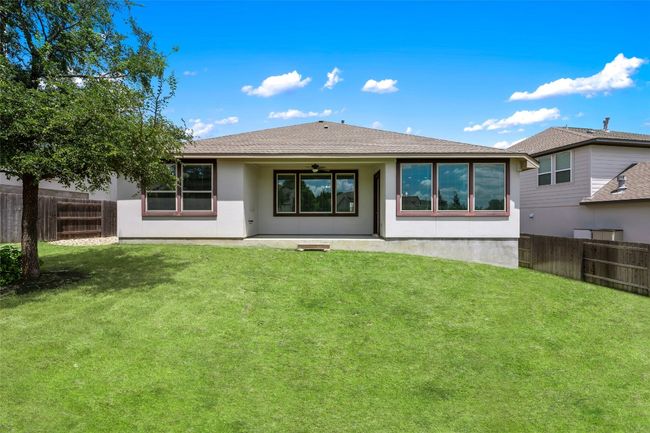 Back of property featuring ceiling fan, a fenced backyard, stucco siding, and a patio | Image 33