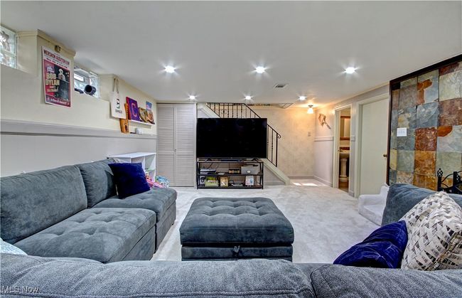 Living area with stairway and carpet flooring | Image 31