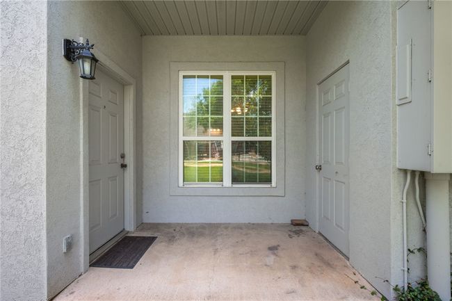 Patio showing backdoor and storage room | Image 12