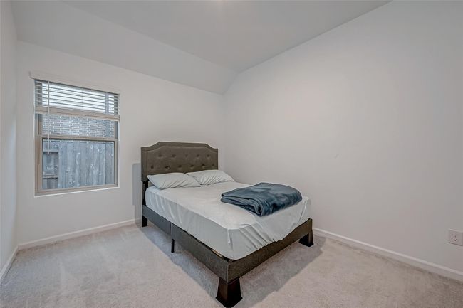 Two additional well-appointed bedrooms, each with their own walk-in closets, provide comfort and privacy for family or guests. | Image 26