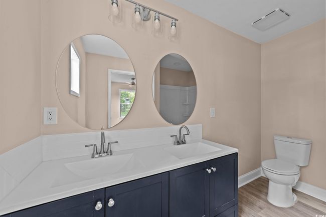 Bathroom with double vanity and wood finished floors | Image 35