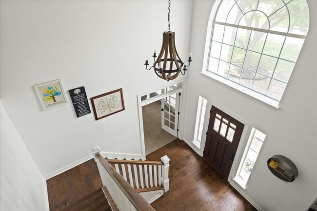 Entry foyer features high ceiling, a stylish chandelier and a wealth of natural light | Image 16