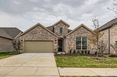 View of front of house with a garage and a front yard | Image 1