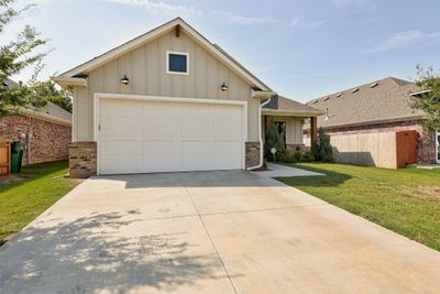 View of front of home with a garage and a front lawn | Image 3