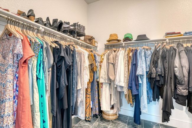 Walk in closet with marble look tile flooring | Image 23