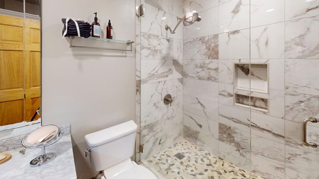 Full bathroom with toilet and a tile shower | Image 16
