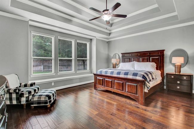1st floor primary suite with engineered wood floors, a fabulous view of the backyard through the wall of windows, and another ceiling with incredible detail! | Image 20