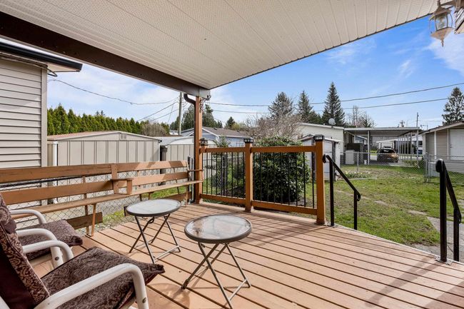 Deck featuring a lawn, a shed, an outbuilding, and fence | Image 23
