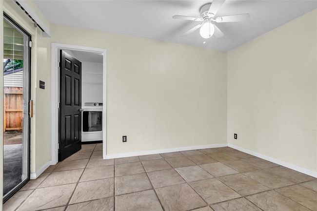 This space functions as a breakfast nook, with an open door that leads to the laundry room for added convenience. | Image 13