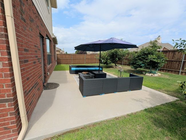 Fenced backyard with an outdoor living space and a patio area | Image 26