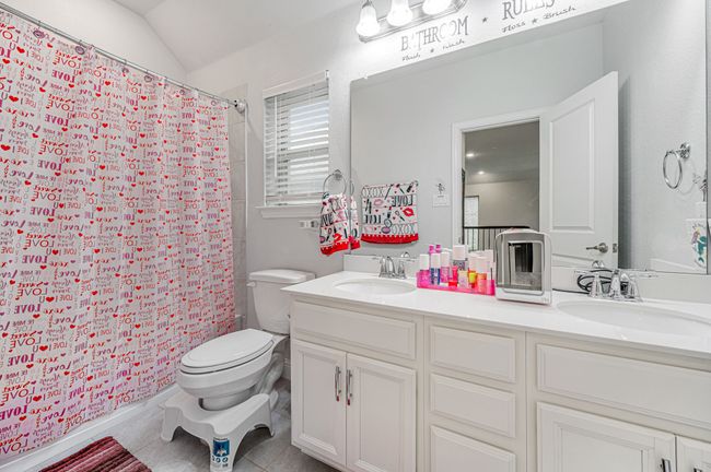 Bathroom featuring double sink and shower | Image 27