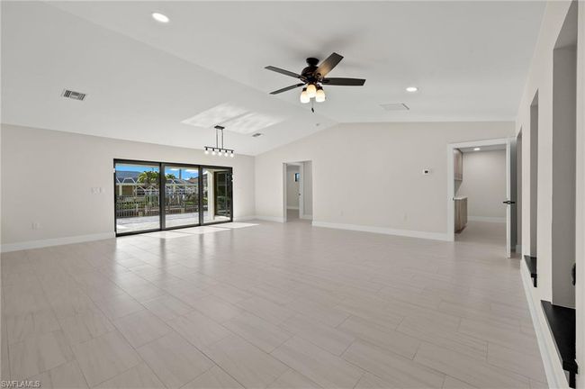 Tiled spare room with vaulted ceiling and ceiling fan | Image 14