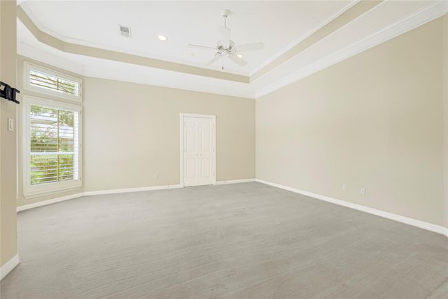 Expansive primary bedroom offering ample space and abundant natural light. | Image 26