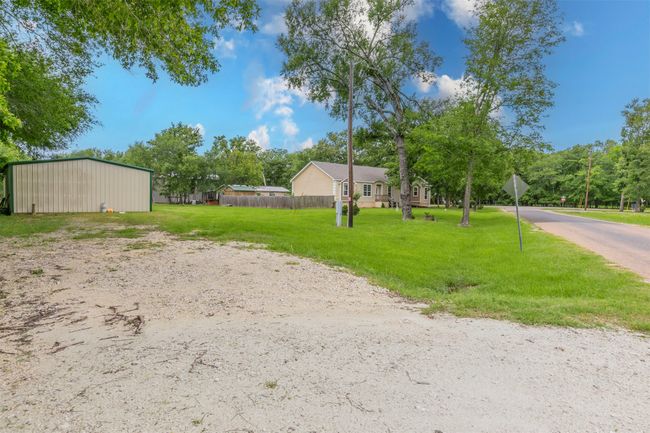 View of yard featuring an outdoor structure, a pole building, and fence | Image 26