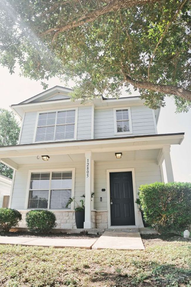 View of front of home with covered porch and stone siding | Image 6