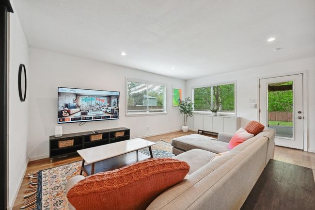 the family room is the perfect spot to unwind at the end of the long day and take in the peaceful wooded views from corner windows. | Image 20