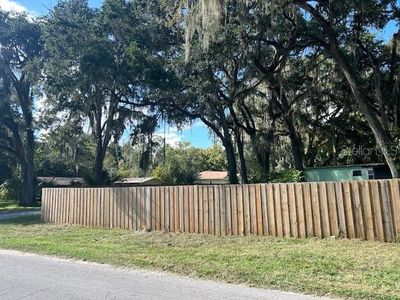 The home is on a corner lot and fenced entirely with a 6' wooden privacy fence | Image 3