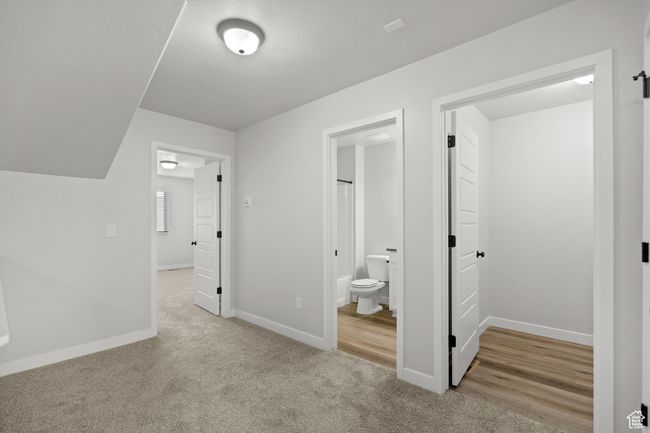 Unfurnished bedroom with carpet flooring and connected bathroom | Image 26