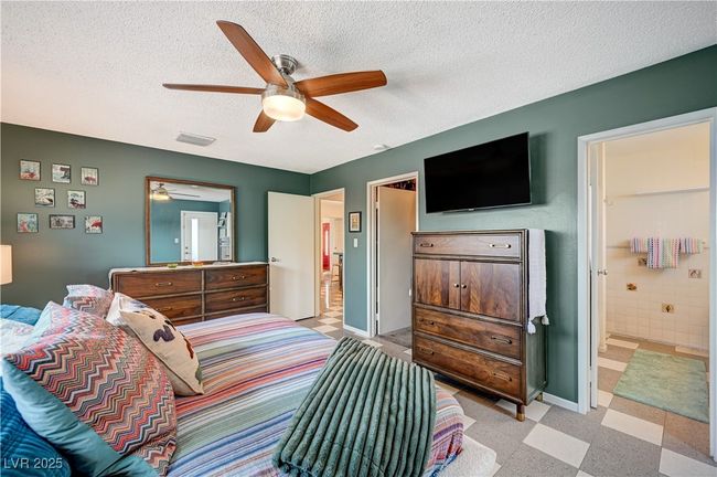 Bedroom with ensuite bath, baseboards, visible vents, and a textured ceiling | Image 26