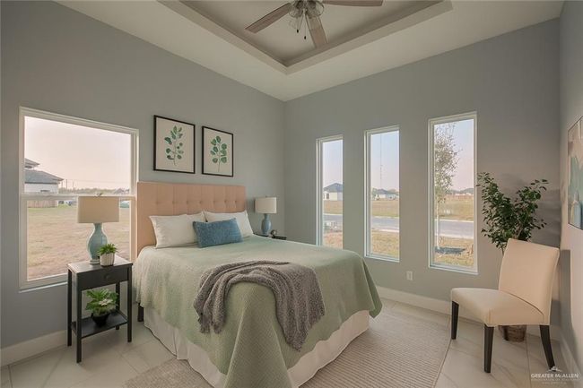 Bedroom with multiple windows, a ceiling fan, and a raised ceiling | Image 22