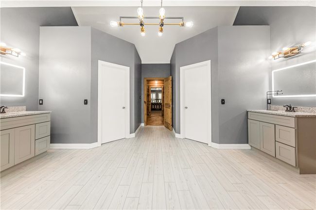 Bathroom with two vanities and wood look tile flooring | Image 19