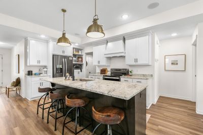 Kitchen offers timeless cabinetry and modern updates. | Image 2