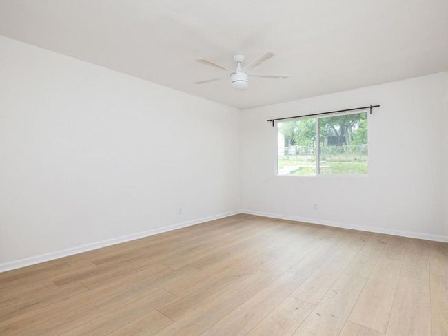 Unfurnished room featuring light wood-type flooring, a ceiling fan, and baseboards | Image 21