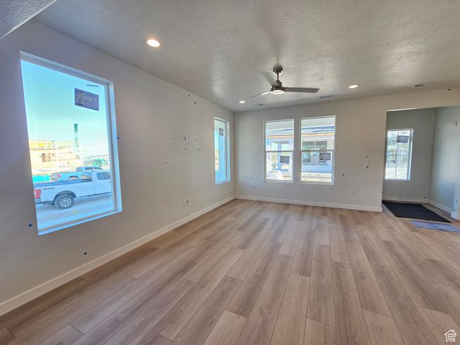 Spare room with light wood-style flooring, ceiling fan, a textured ceiling, and recessed lighting | Image 14