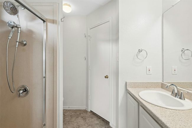 Bathroom with a stall shower and vanity | Image 16