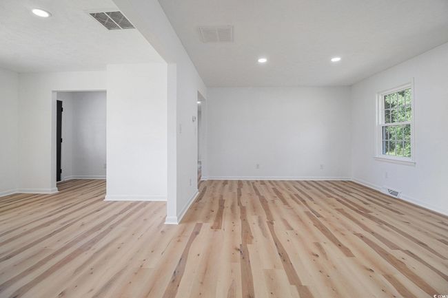 Open Concept View from the Kitchen showing both Family Room & Living Room. New luxury vinyl plank flooring offers durable, waterproof, and easily maintained floors throughout the entire home-NO CARPET!! | Image 11