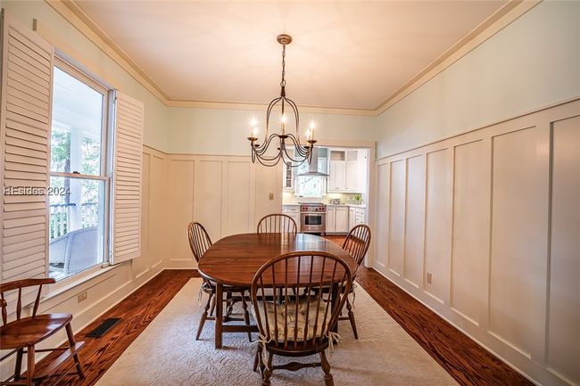 Dining area with an inviting chandelier, dark hardwood / wood-style flooring, and ornamental molding | Image 14