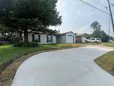 Single story home featuring a front yard and a garage | Image 2