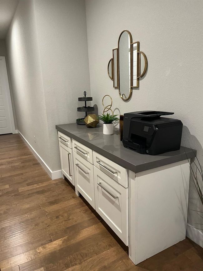 Bar featuring dark wood-type flooring and a textured wall | Image 19